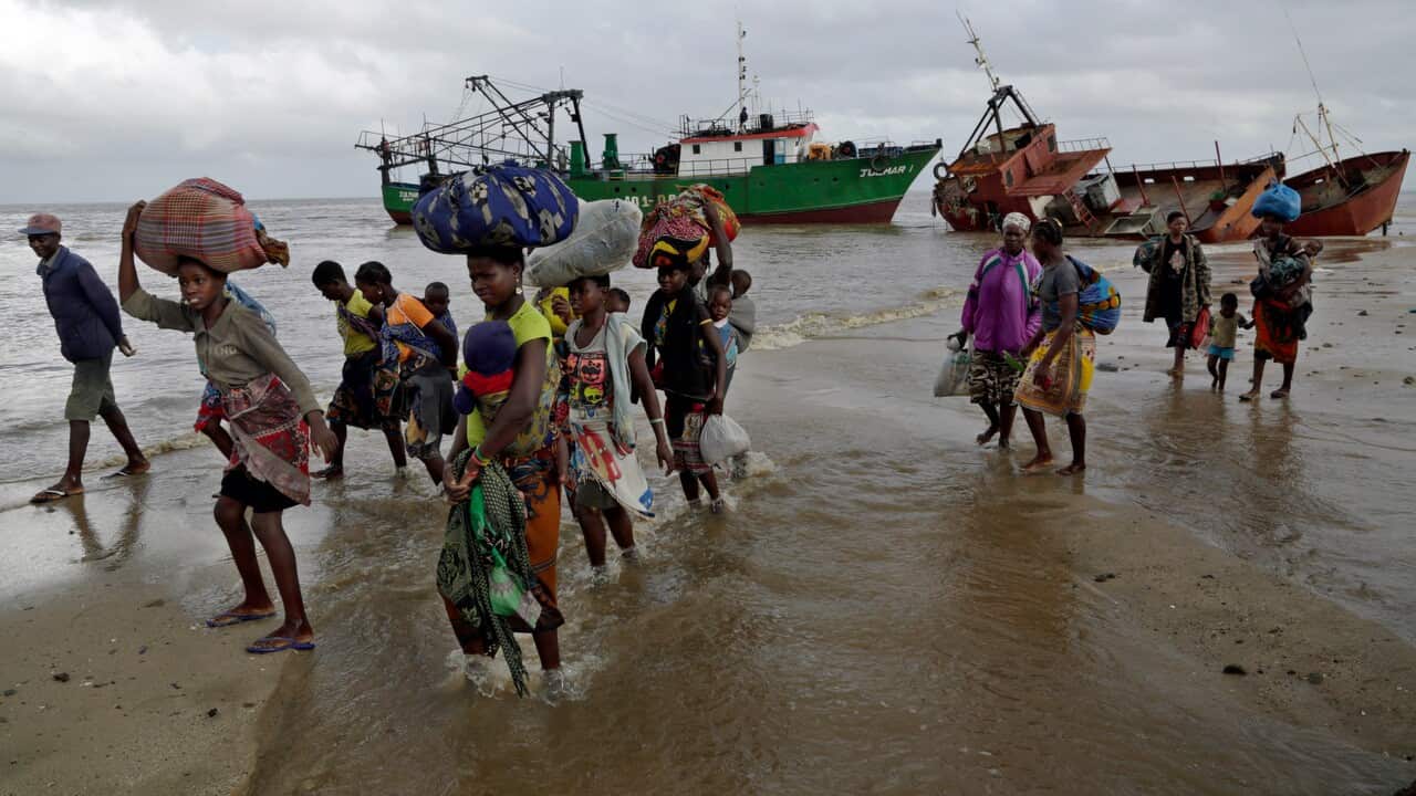 Displaced families arrive after being rescued by a boat from a flooded area of Buzi district, Mozambique, in the aftermath of Cyclone Idai.