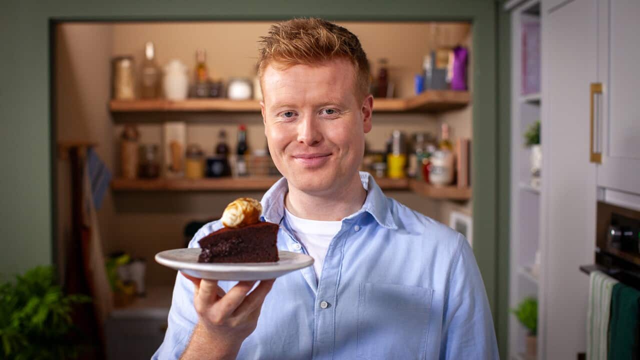 Mark Moriarty holds his flourless chocolate cake