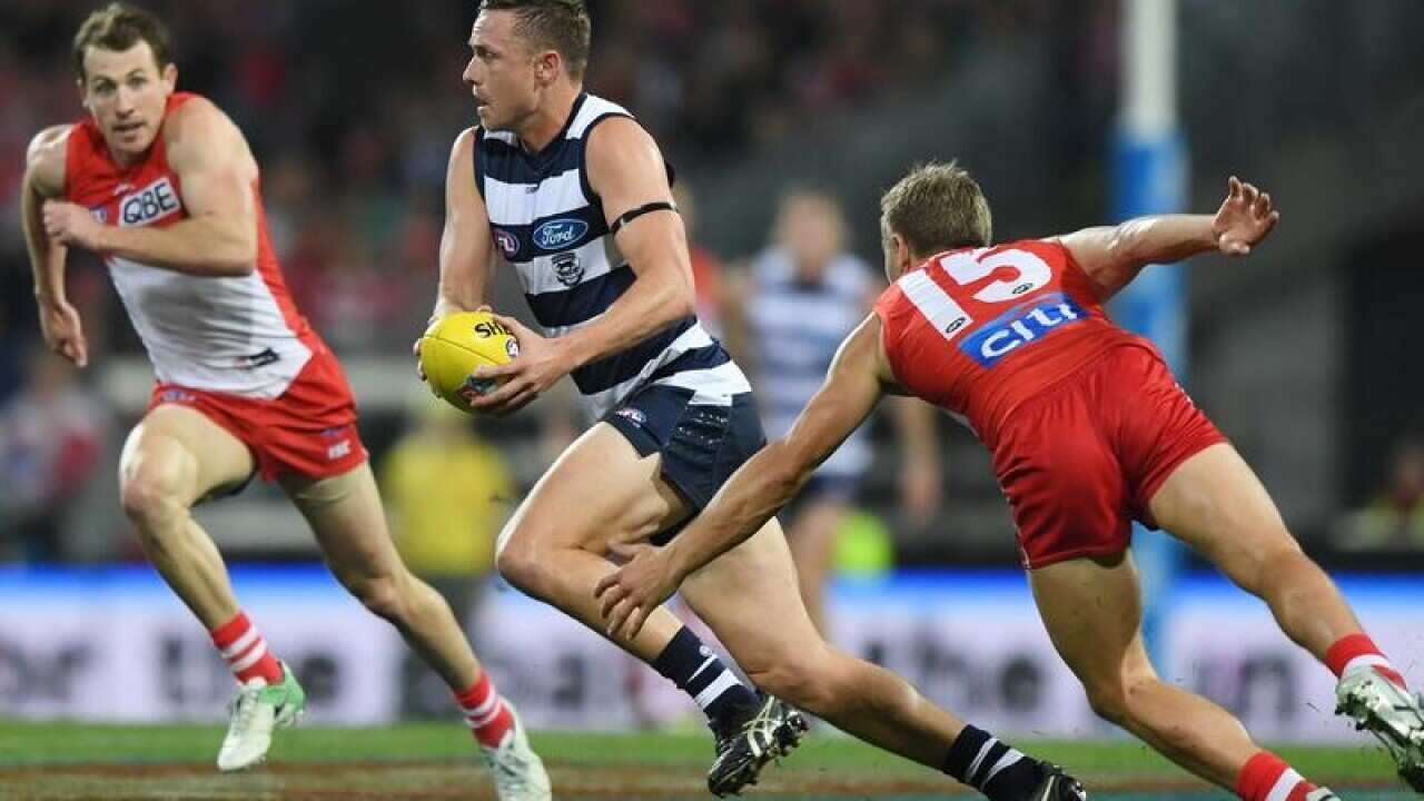 Joel Selwood of the Cats runs with the ball during Round 16.