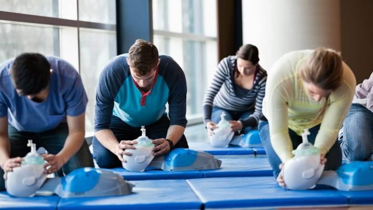 Group of people learning CPR in fitness center