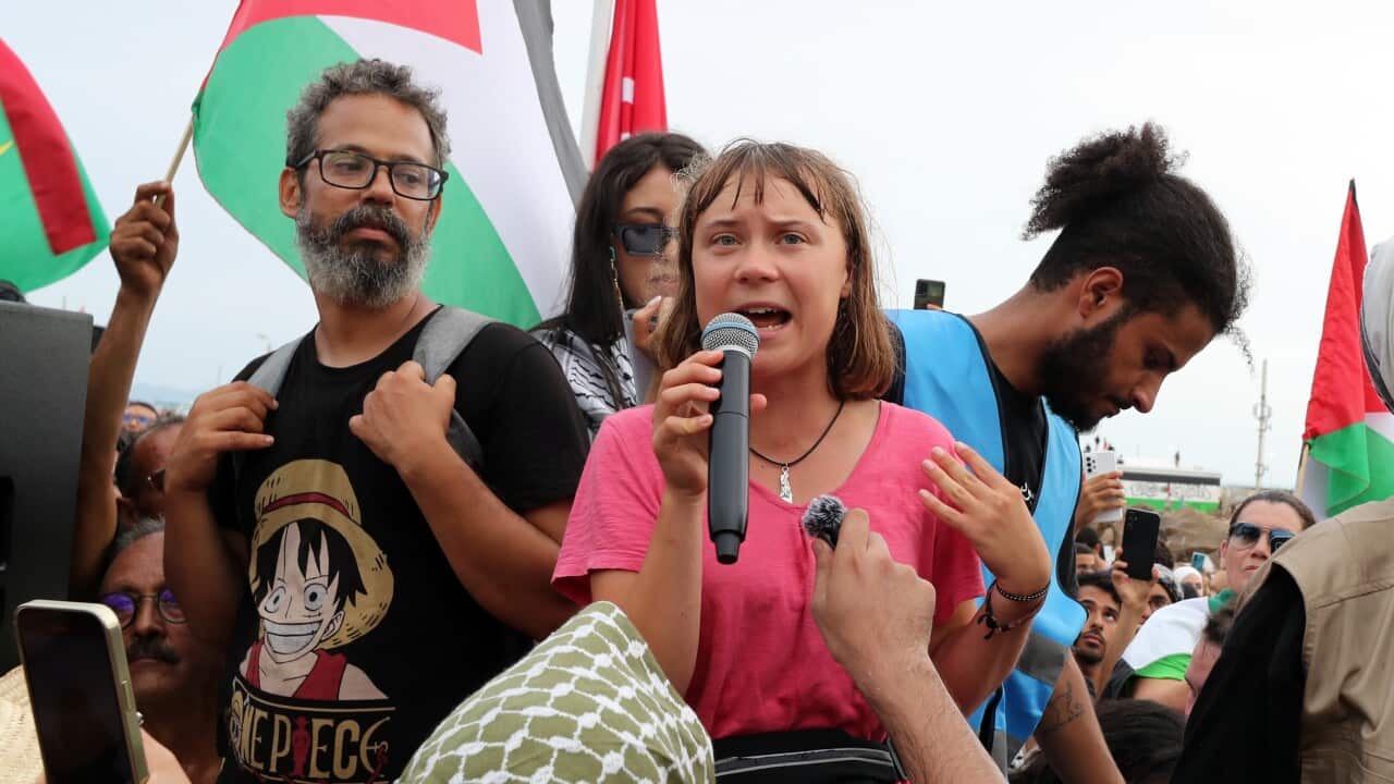 Greta Thunberg speaks in front of fellow activists and supporters
