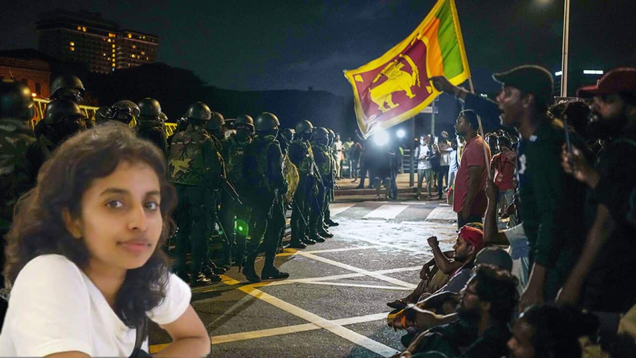 Army soldiers stand guard as protesters shout slogans at the site of a protest camp outside the Presidential Secretariat in Colombo, Sri Lanka, Friday, July 22, 2022. (AP Photo/Rafiq Maqbool)