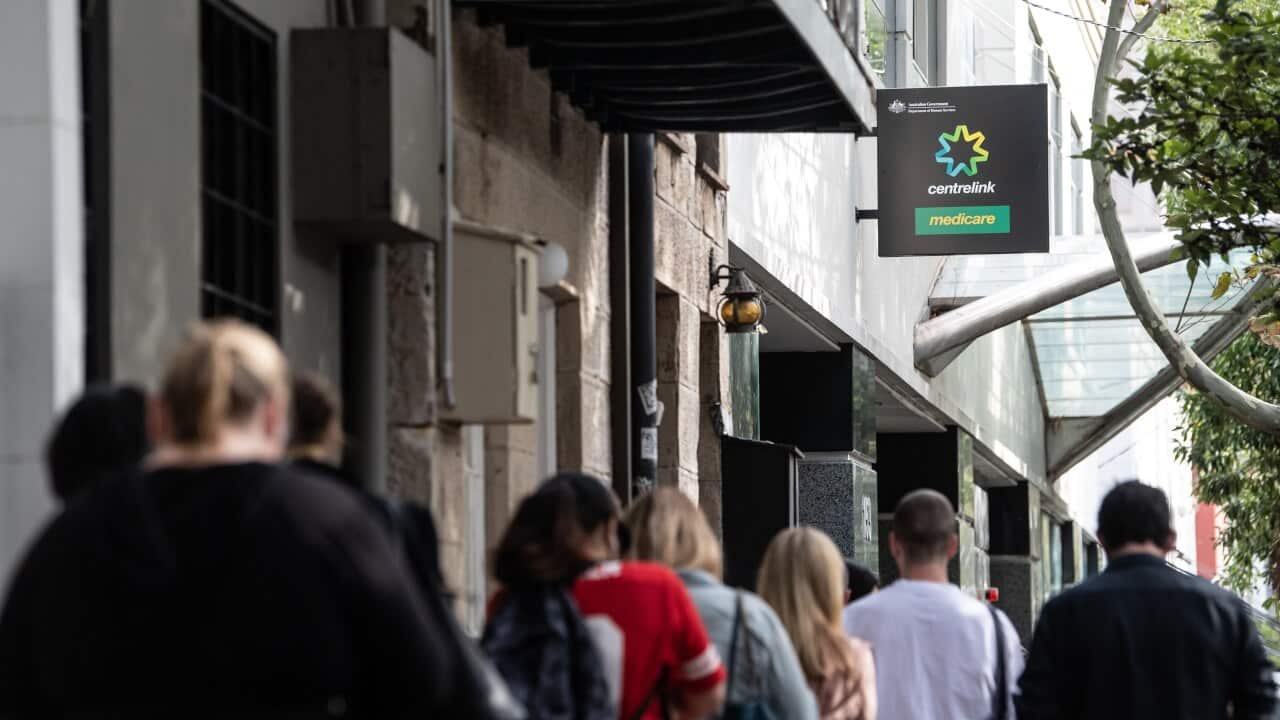 People queue for access to a Centrelink Service Centre in Sydney.