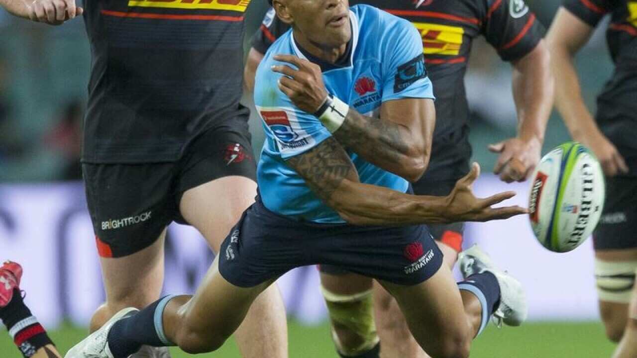 Israel Folau of the Waratahs makes a break.