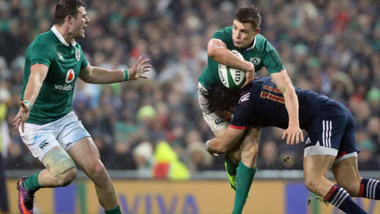 Ireland's Garry Ringrose is tackled by France's Noa Nakaitaci