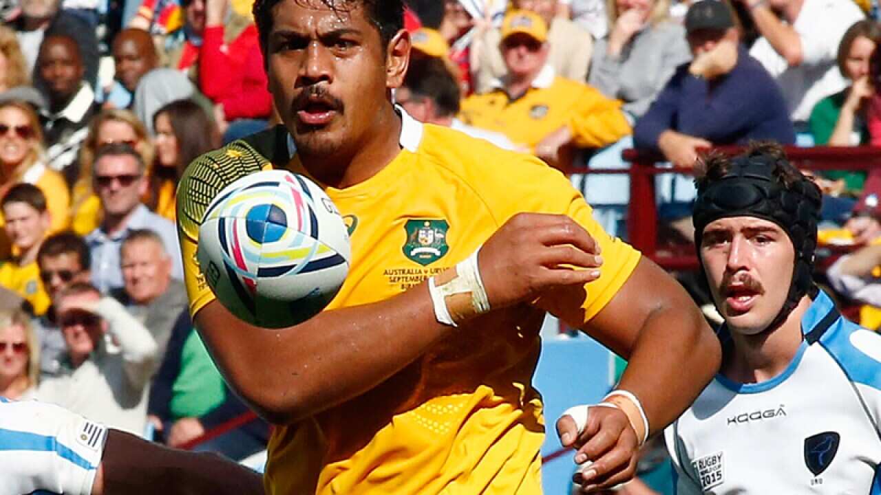Australia's Will Skelton passes the ball against Uruguay