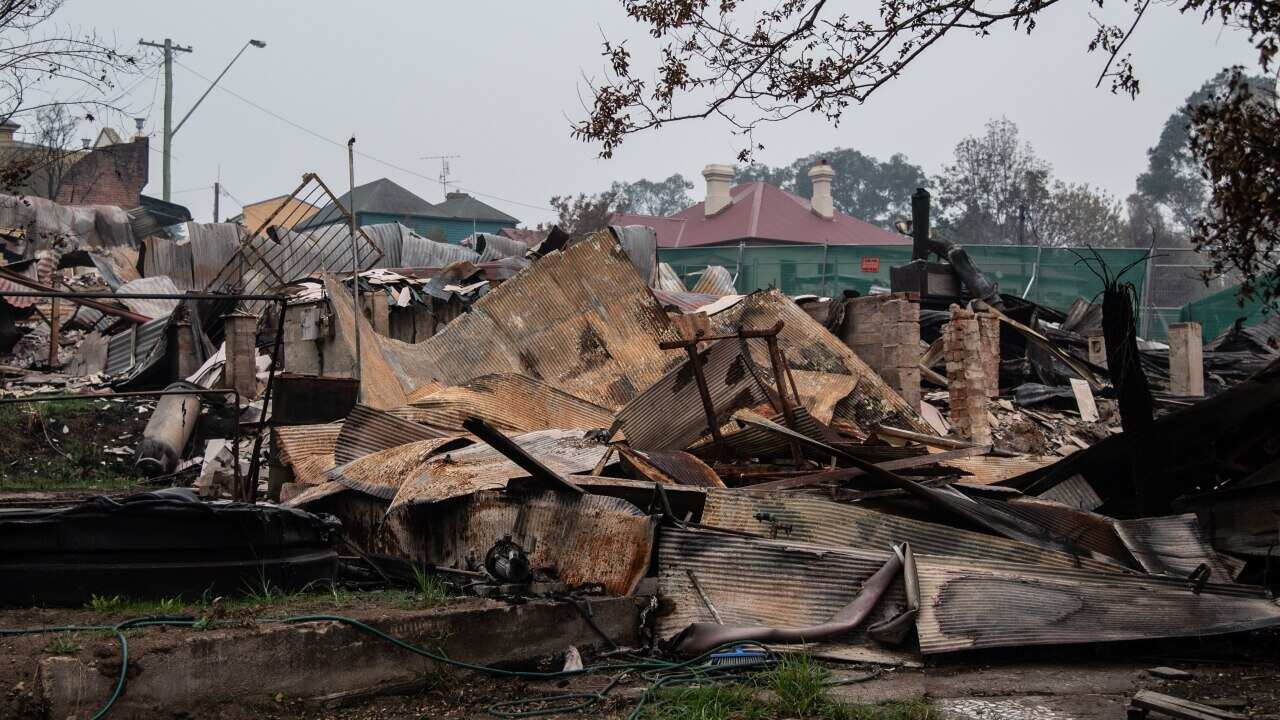 The remains of burnt-out businesses, in close proximity to unaffected buildings in Cobargo, NSW.