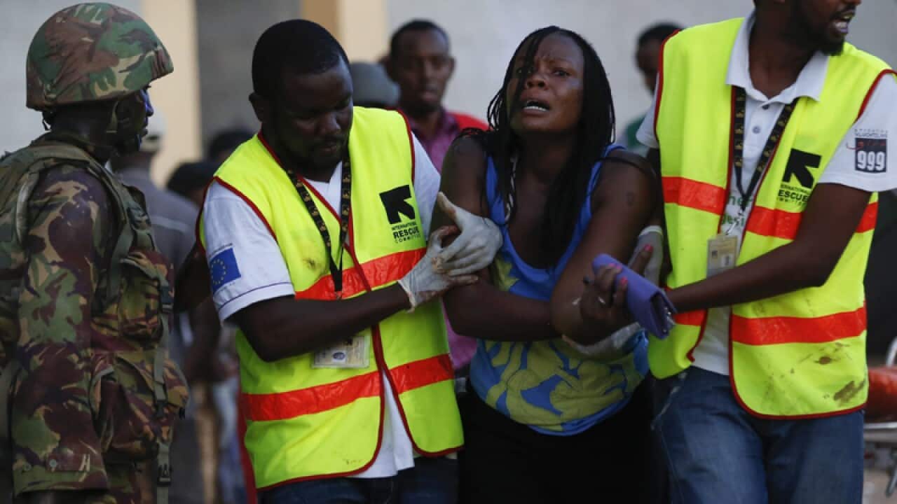 A woman reacts as she is rescued from Garissa University
