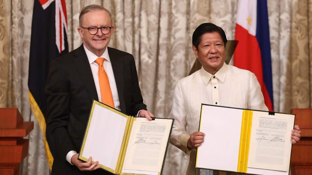 Philippine President Ferdinand Marcos Jr and Australian Prime Minister Anthony Albanese display signed documents (AAP)