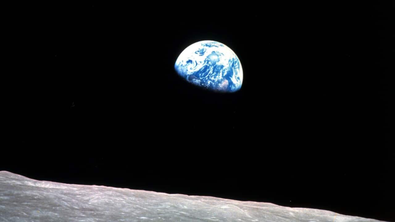 Earth behind the moon's surface.
