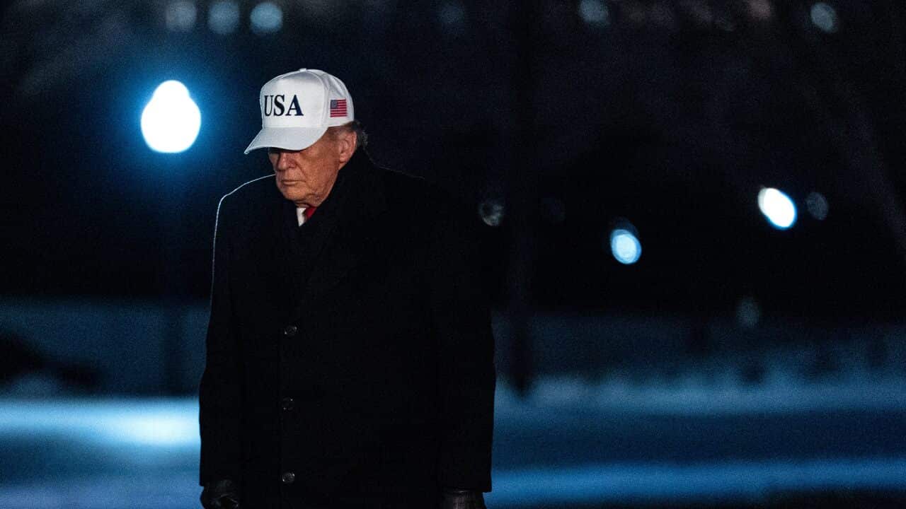 US President Donald Trump walks on the South Lawn of the White House after arriving on Marine One in Washington, DC