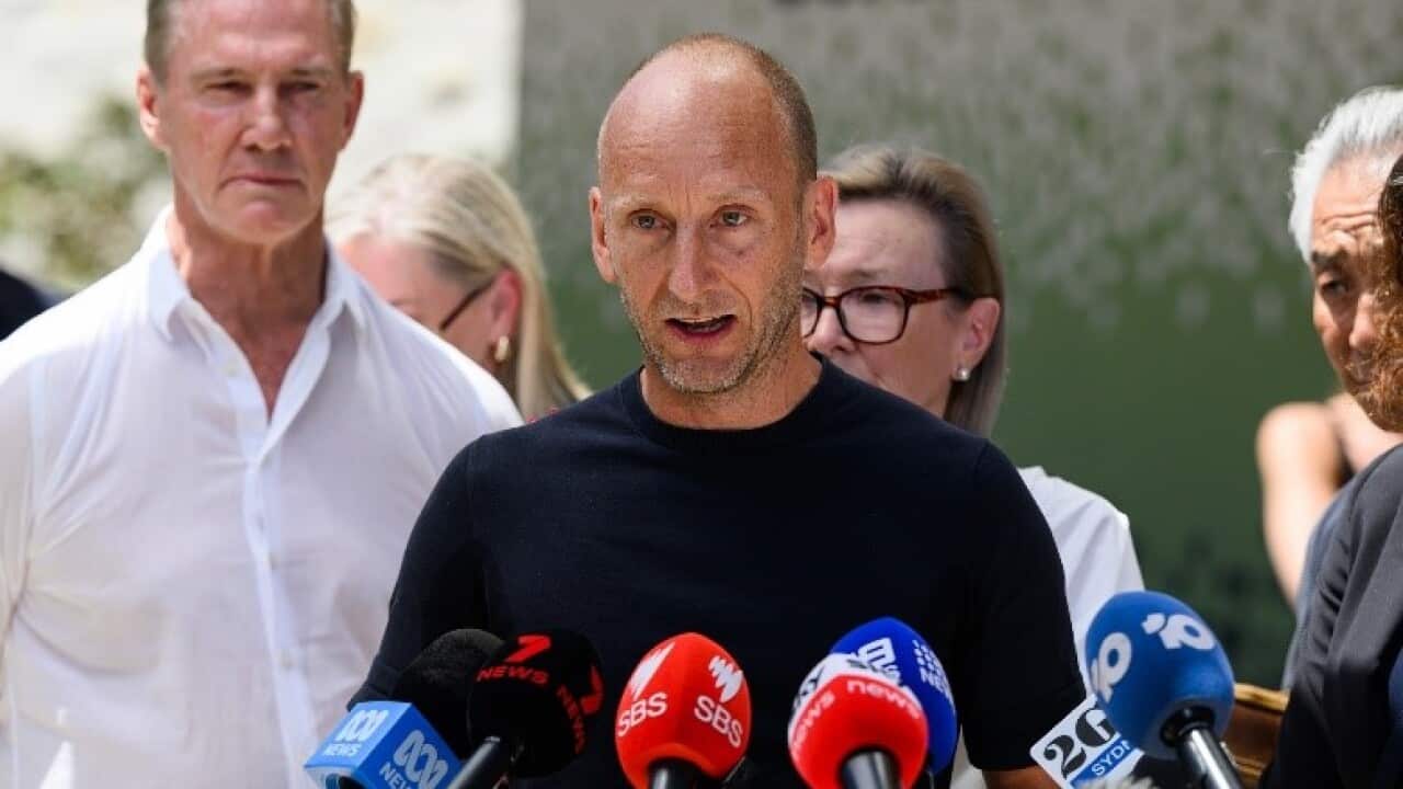 Noel McLaughlin (centre), partner of victim Jade Young, outside the Lidcombe Coroners Court in Sydney (AAP).jpg
