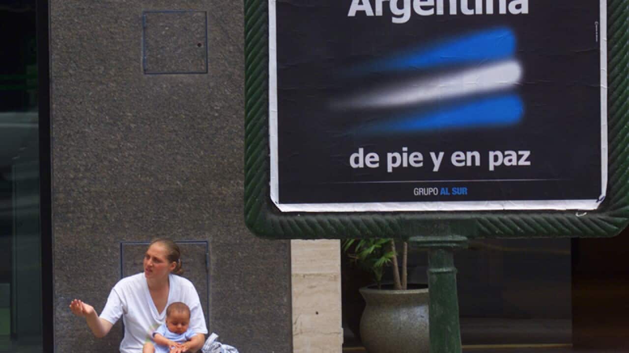 A woman hold her son as she begs in Buenos Aires