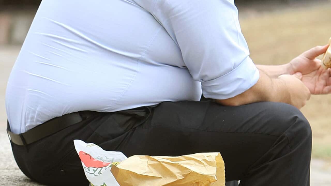 an overweight man eating.
