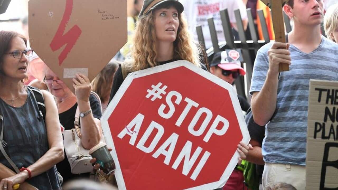 Anti Adani coal mine protesters engage in a sit-in protest in Brisbane