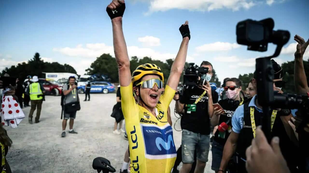Annemiek Van Vleuten (C) wearing the overall leader's yellow jersey celebrates after winning the 8th and final stage of the new edition of the Women's Tour de France cycling race.