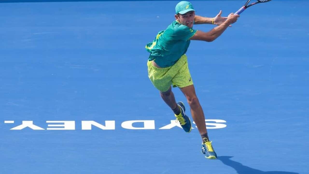 Alex De Minaur of Australia plays a forehand to Fernando Verdasco.