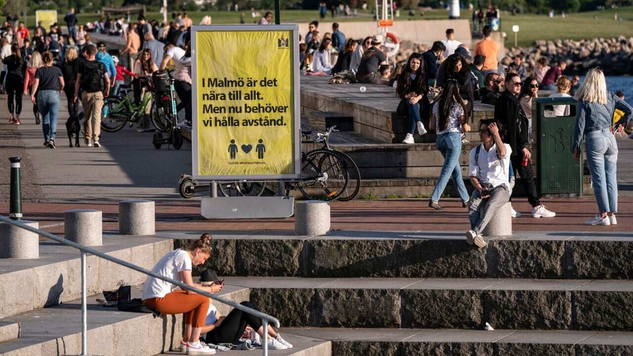 People enjoy the warm evening weather in Malmo, Sweden