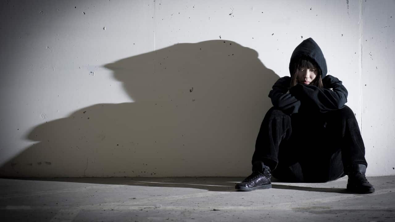 Girl sitting in shadow
