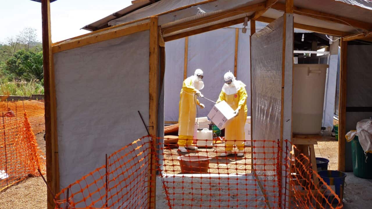 Healthcare workers prepare isolation and treatment areas for Ebola.