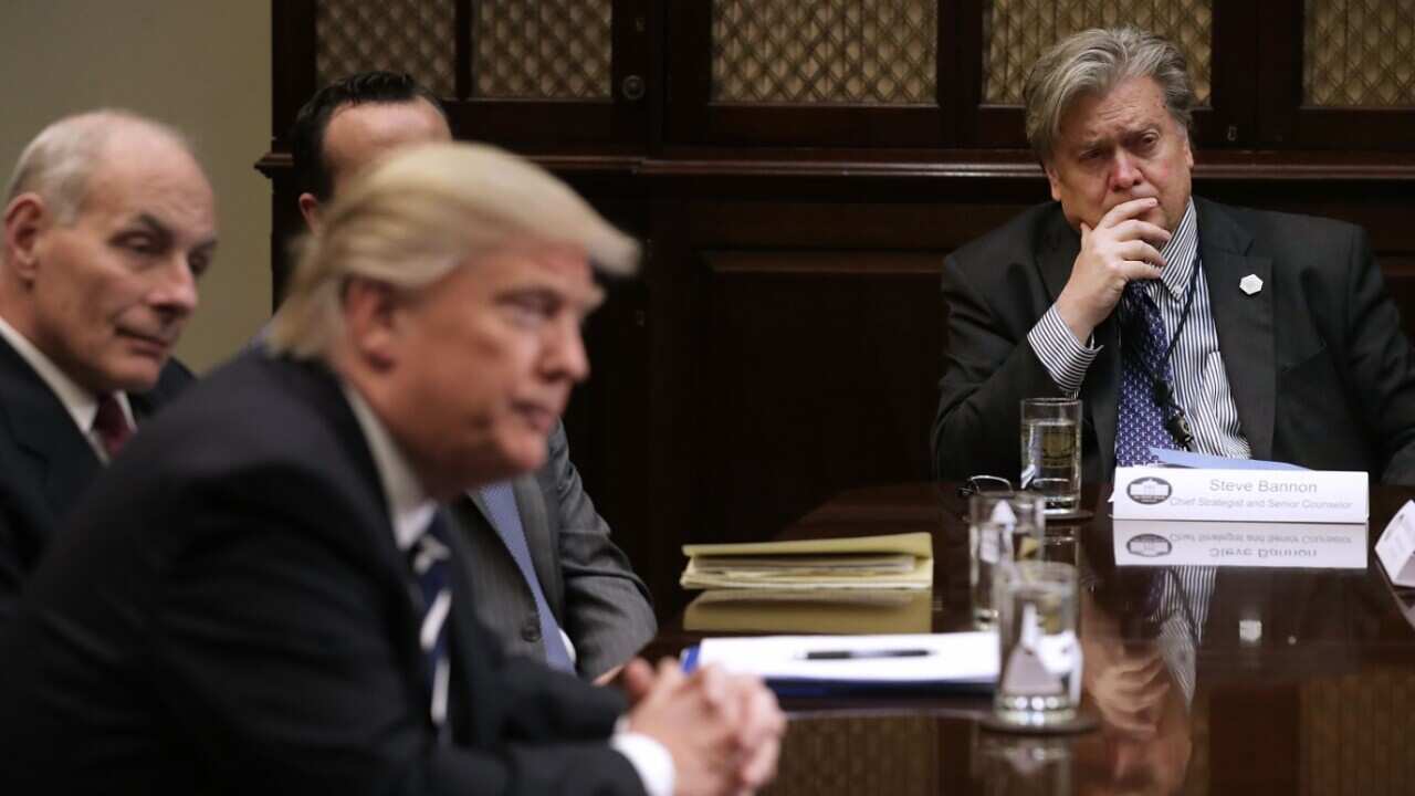 Then White House Chief Strategist Steve Bannon (R) listens to U.S. President Donald Trump at the beginning of a meeting on January 31