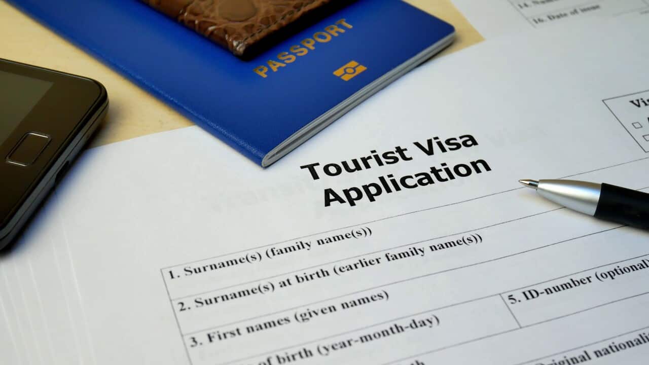 tourist-visa-application-form-with-passport-and-pen-document-with-passport-apply-and-p-SBI-351307866.jpg