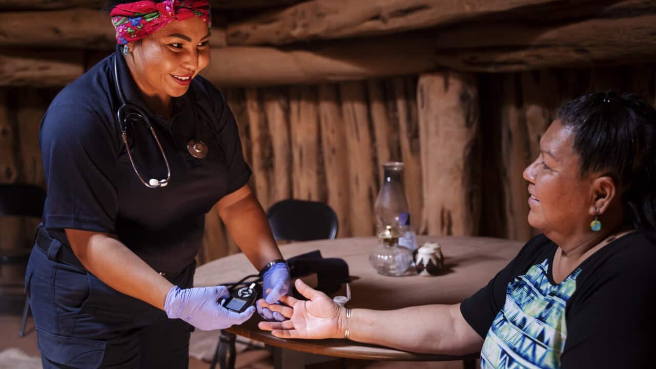 Young Woman Paramedic Emergency Medical Technician EMS checking glucose on blood