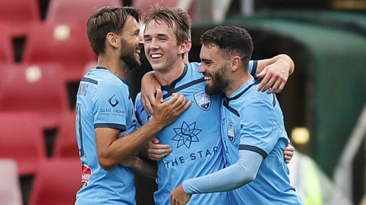 Calem Nieuwenhof celebrates a goal with Milos Ninkovic (L) and Anthony Caceres (R)