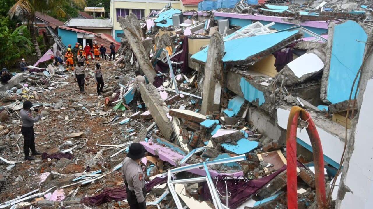 Police search for anyone trapped under the rubble at Mitra Manakarra hospital in Mamuju on 17 January, 2021. 