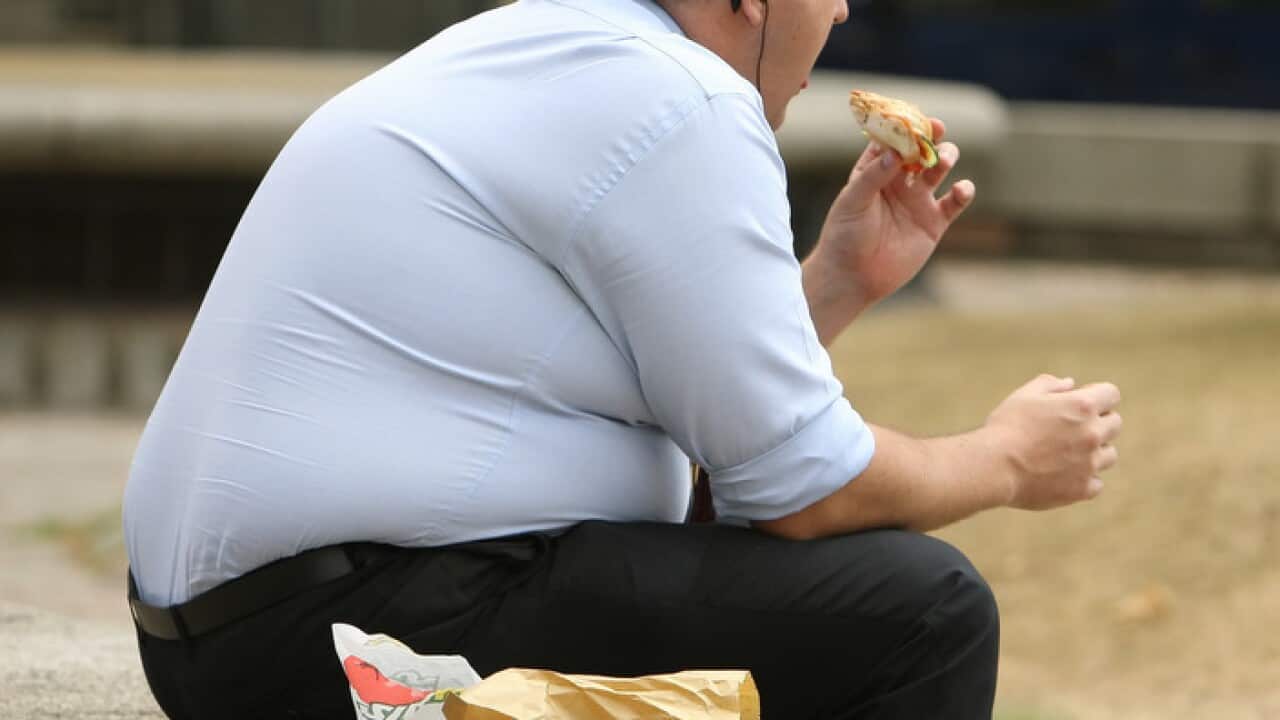 An overweight man eats fast food.. Picture date: Wednesday July 28, 2010. Photo credit should read: Dominic Lipinski/PA