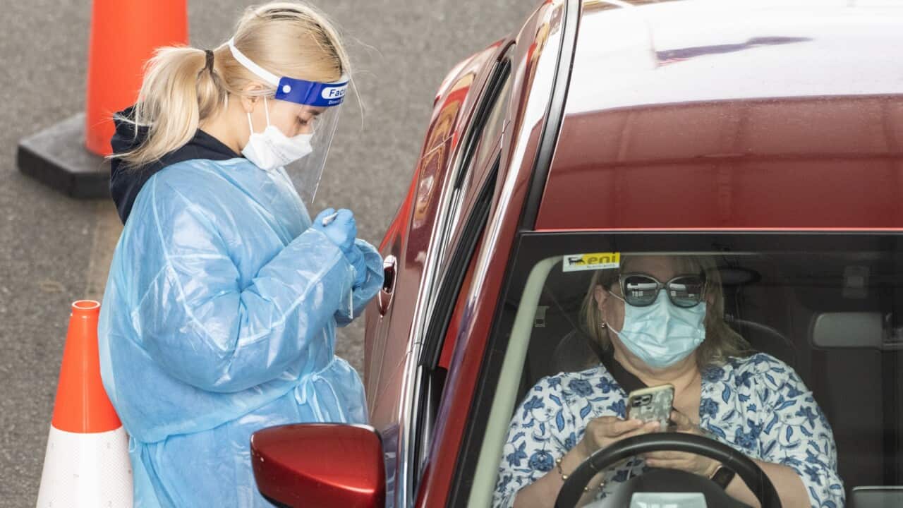 Healthcare workers administering COVID-19 tests at a drive through test centre in Sydney