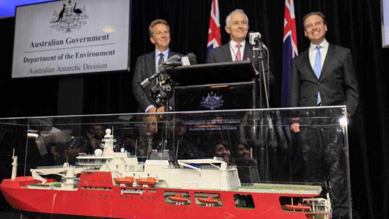 Australian Prime Minister Malcolm Turnbull (centre) with the Director of the Australian Antarctic Division (AAD) Dr Nick Gales (left), and Federal Environment Minister Greg Hunt (right), speak at the announcement of a new Antarctic icebreaker ship in Hoba