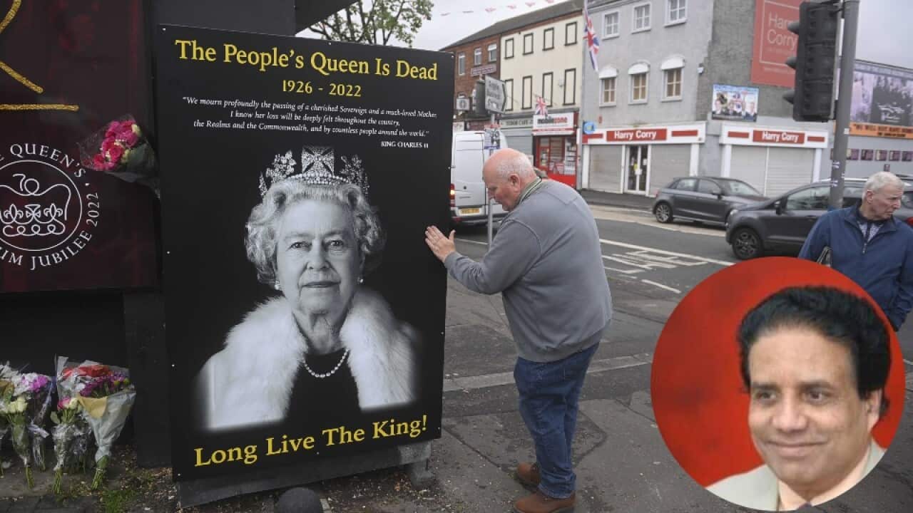 Council workers and local community representatives hang a mural on a wall on Crimea street off the Shankill road in Belfast following the death of Queen Elizabeth II on Thursday.