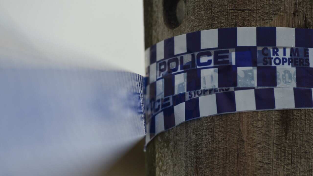 Police tape is seen at a home