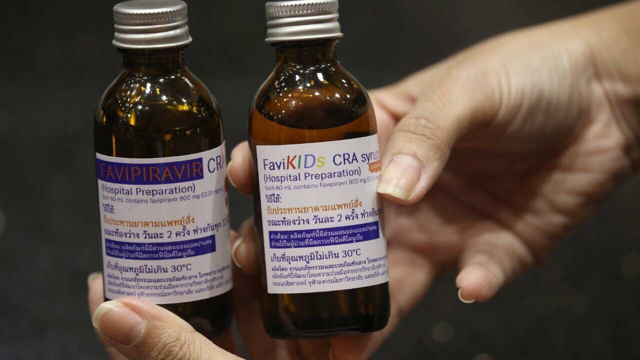 A Chulabhorn Royal Academy's officer displays liquid antiviral drug Favipiravir syrup (AAP Image-EPA-NARONG SANGNAK).