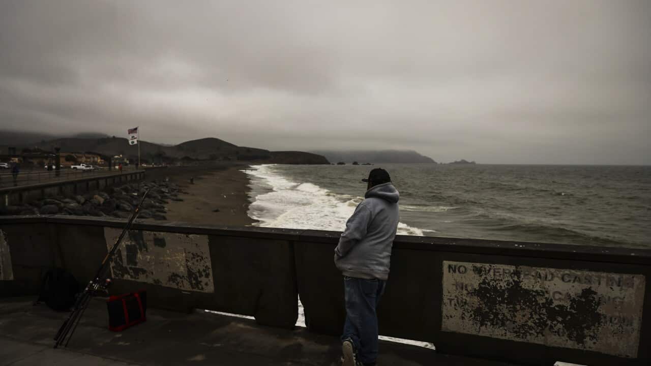 Fisherman looks out at the beach