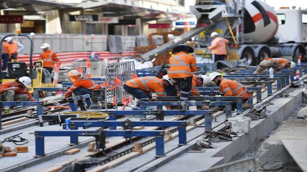Workers are seen on the George St, Sydney CBD Light Rail Project.