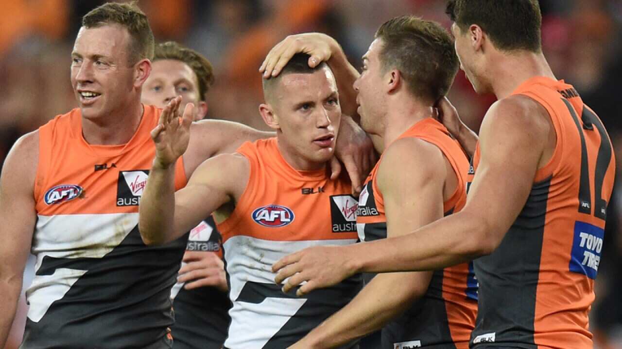 Tom Scully (C) celebrates after scoring a goal