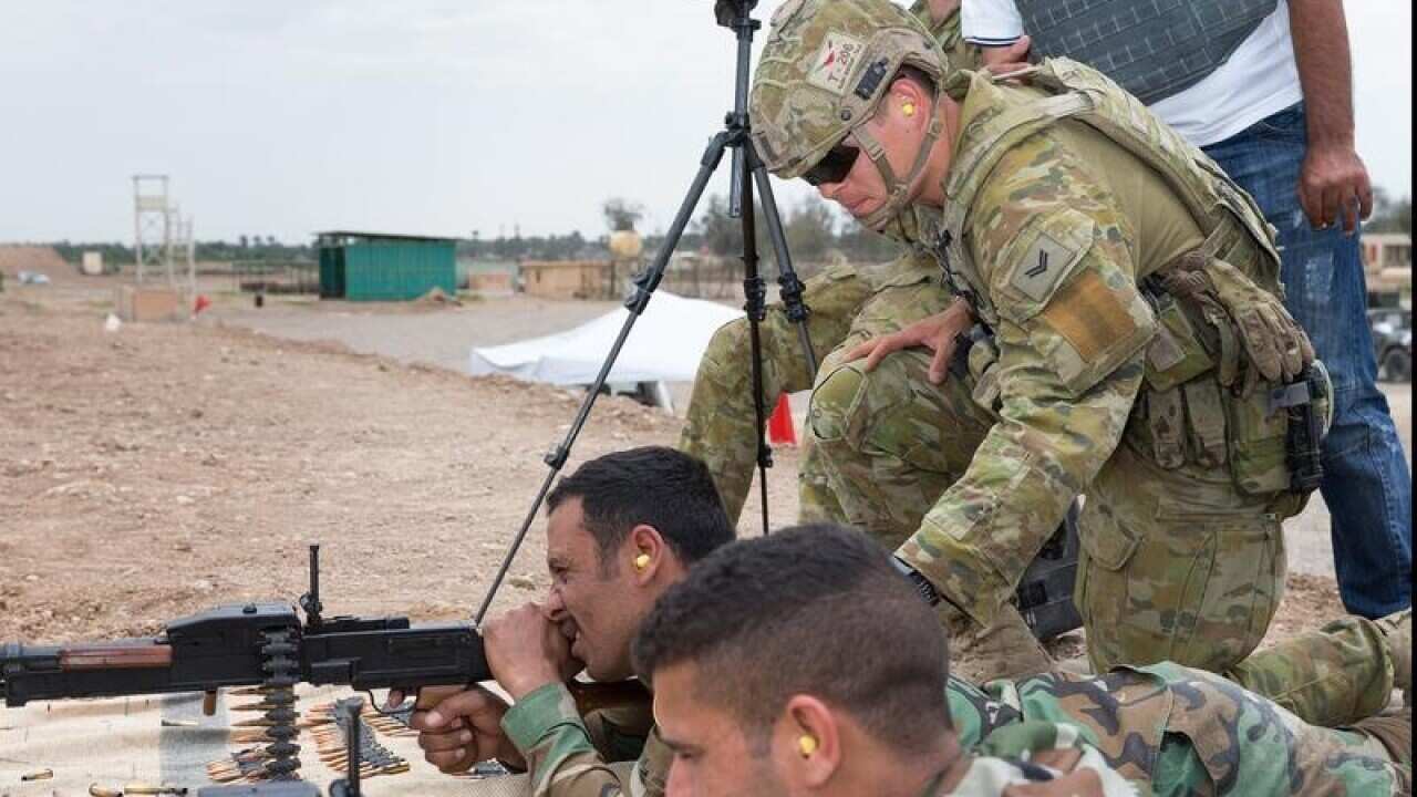 An Australian Army corporal assists in training Iraqi security forces.