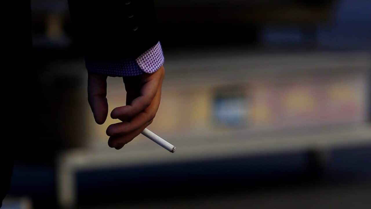 A man smokes a cigarette