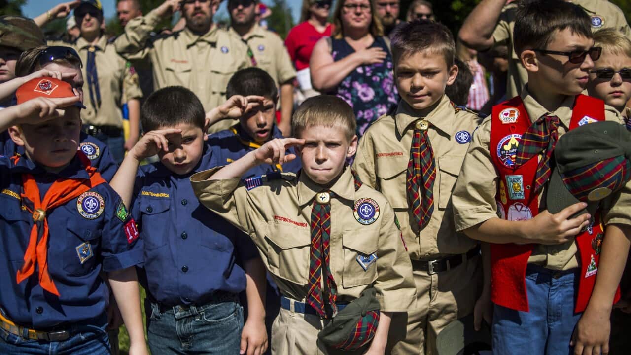 In this Monday, May 29, 2017 file photo, Boy Scouts and Cub Scouts salute during a Memorial Day ceremony in Linden, Mich. On Wednesday, Oct. 11, 2017.