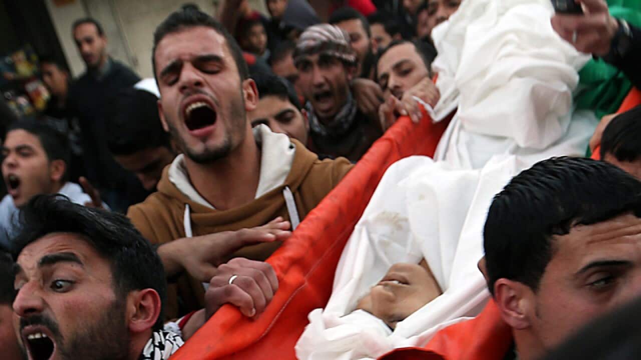 Palestinian mourners carry the body of Bilal Aweida