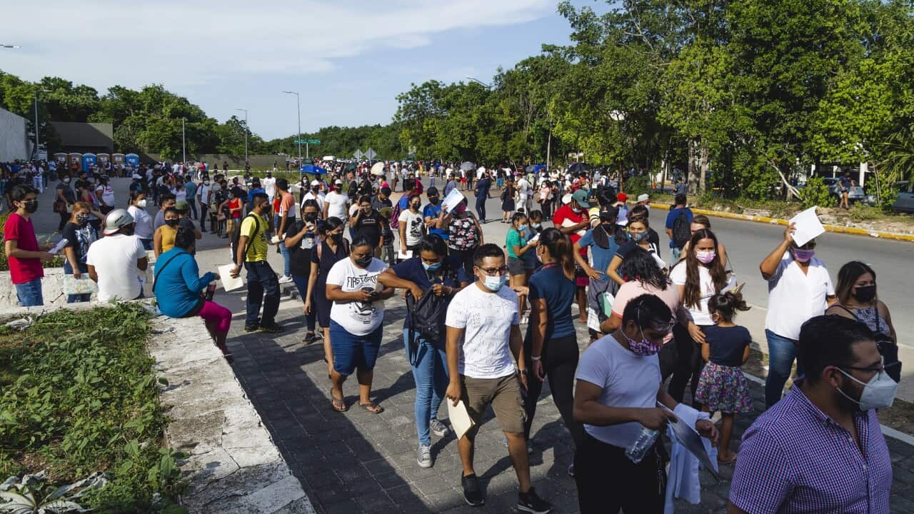 People queue to enter a vaccination centre at Playa del Carmen in Mexico