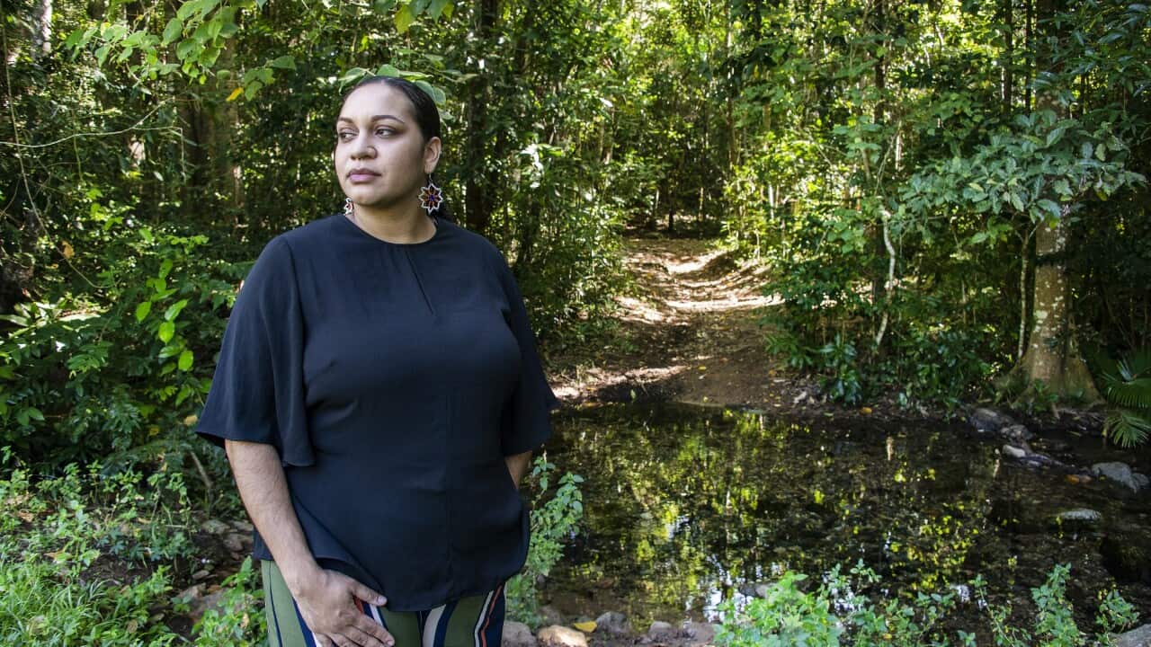 Youth Verdict First Nations lead and co-director Murrawah Johnson stands among trees on land threatened by Clive Palmer’s Galilee Coal Project