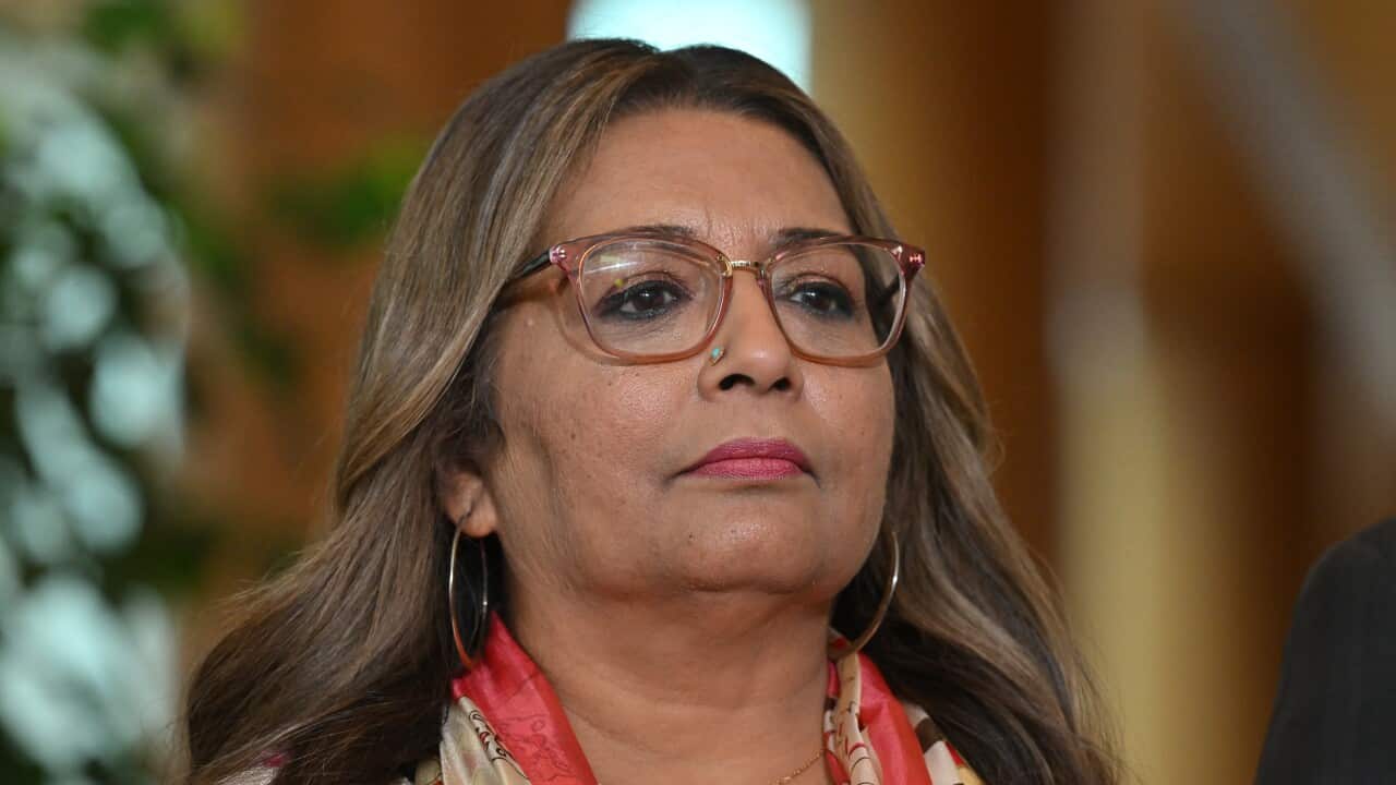 Mehreen Faruqi looks ahead, wearing glasses.
