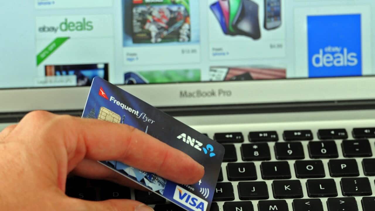 A credit card in front of an online shopping site