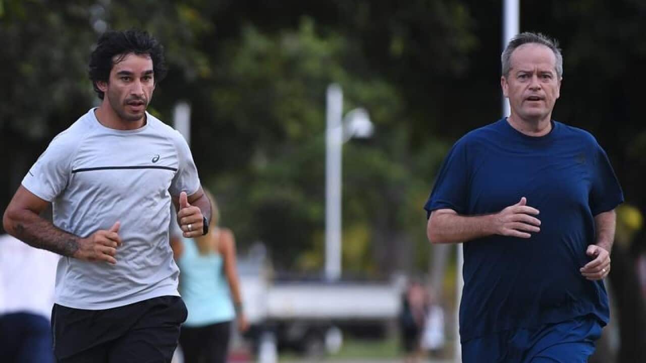 Bill Shorten and Jonathan Thurston on a run in Townsville.