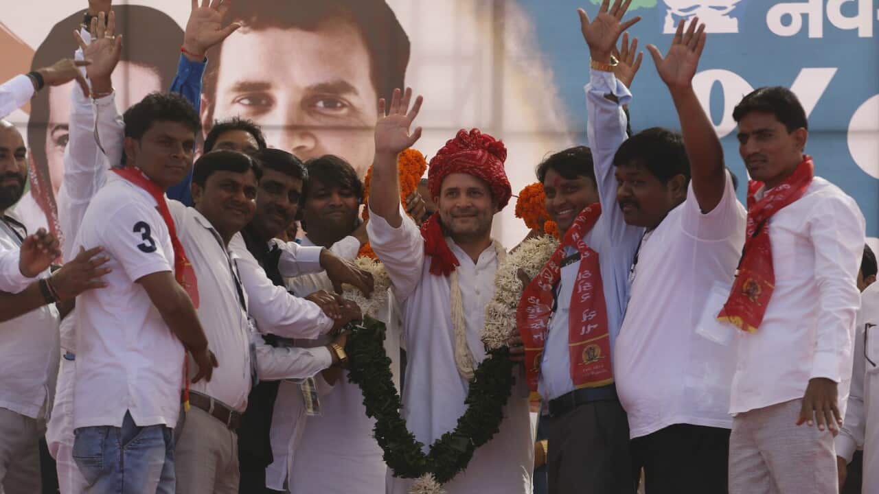 Congress party vice president Rahul Gandhi waves as he is garlanded during a rally in Gandhinagar, India, Monday, Oct. 23, 2017. Other backward Class leader Alpesh Thakor joined the Congress party during the rally in Gandhinagar. Gujarat Assembly election