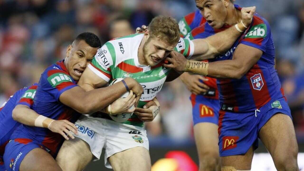 Thomas Burgess of the Rabbitohs is tackled by Daniel and Jacob Saifiti