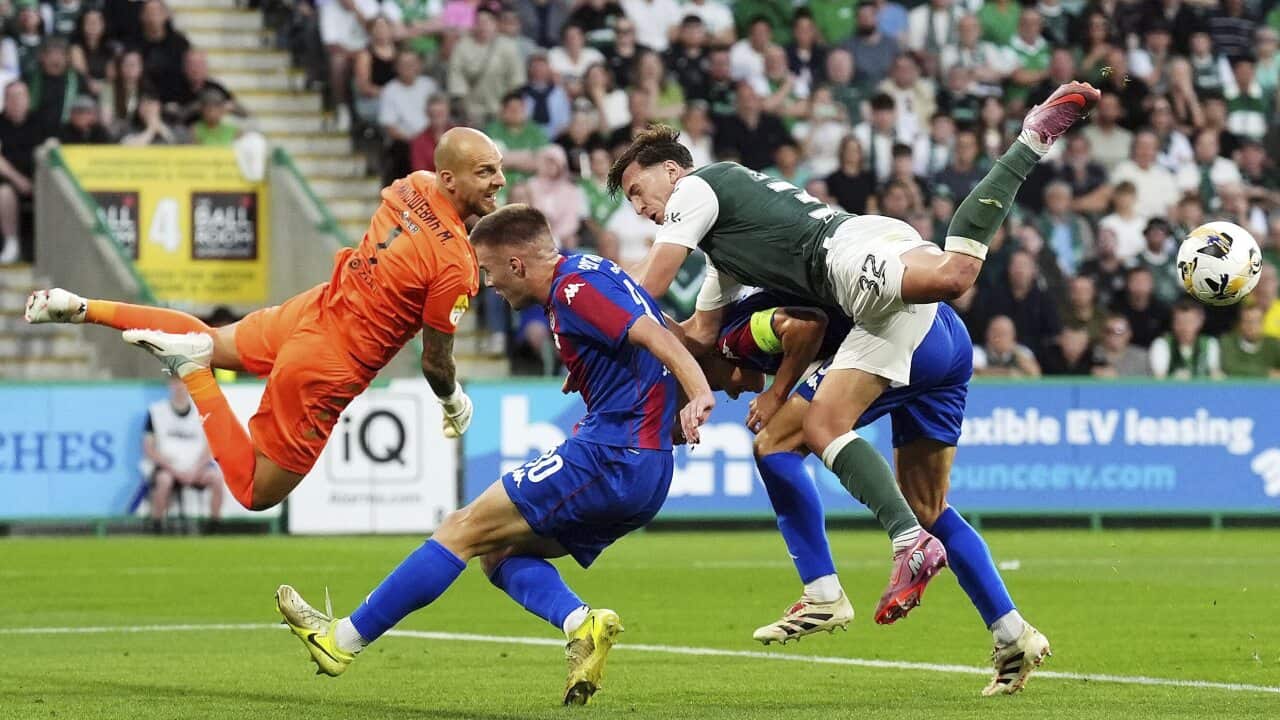 Hibernian's Josh Campbell challenges Partizan goalkeeper Marko Milosevic for the ball during the UEFA Conference League match in Edinburgh